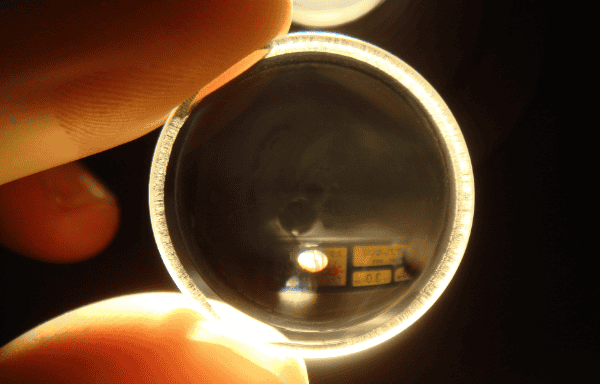 person holding lens image